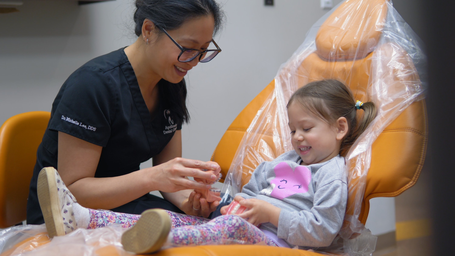 Dentist providing dental care to a child at Apollonia Dental Clinic in Edmonton
