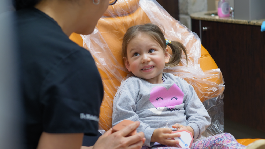 Child patient smiling in the dental chair at Apollonia Dental Clinic Edmonton