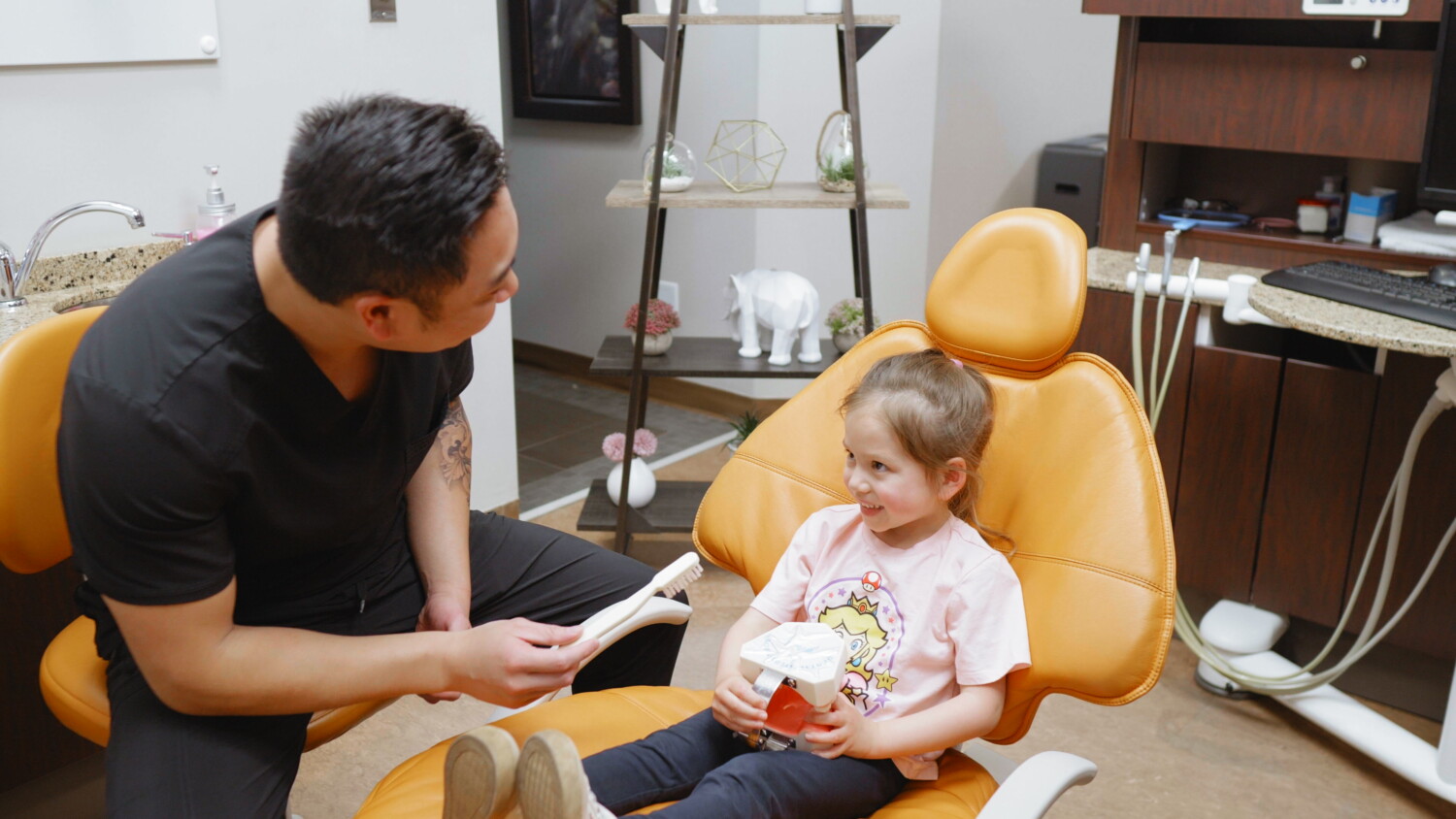 Dentist and a smiling child patient during a pediatric sleep and airway screening.