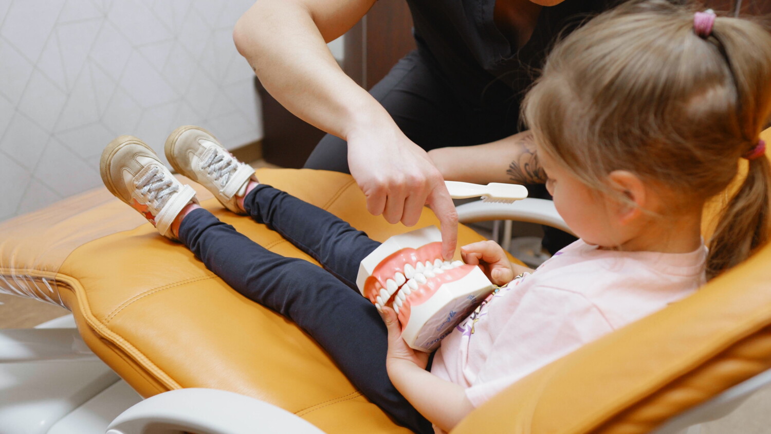 Dentist showing a child implant procedure