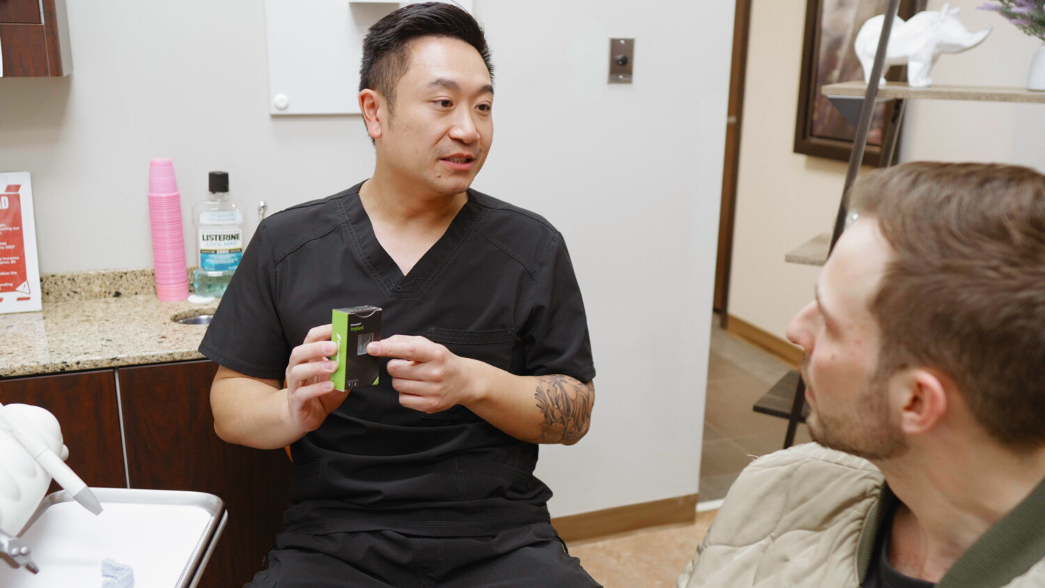 Dentist explaining a dental implant procedure to a patient