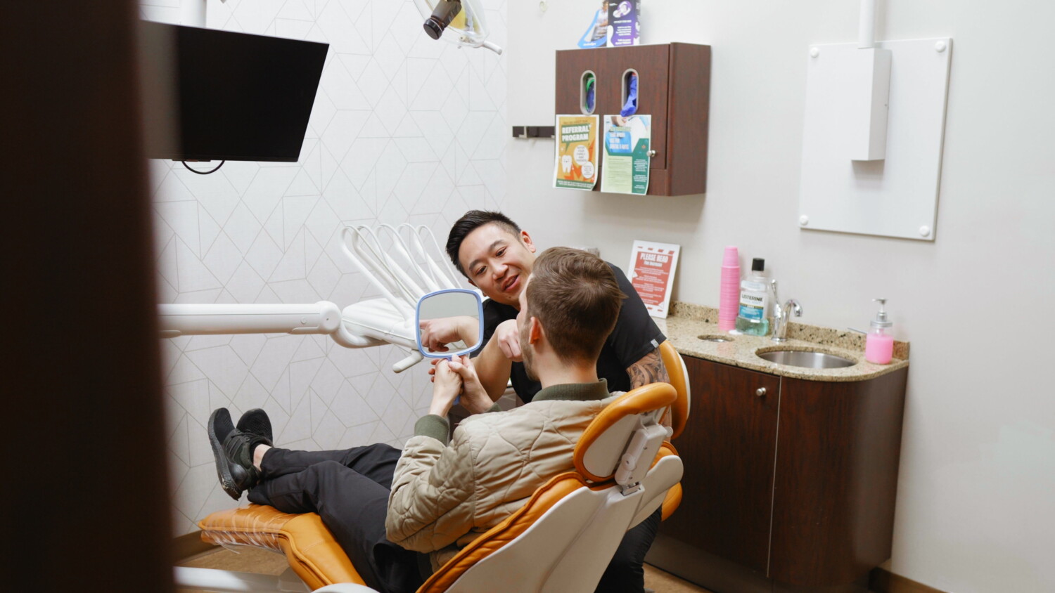 Dentist pointing out a missing tooth gap on a dental X-ray